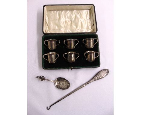 A quantity of silver to include a cased set of six shot cups in the form of tygs, a caddy spoon and a button hook