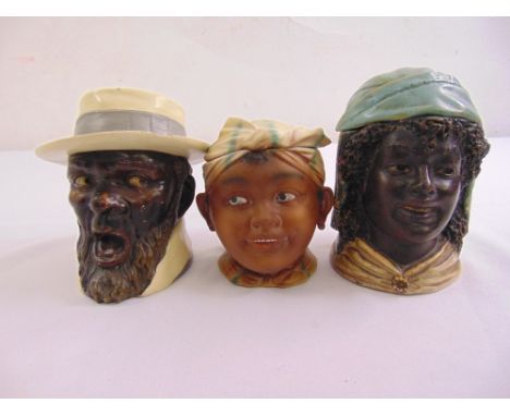 Three 19th century ceramic tobacco jars, in the form of African figurines one with the impressed mark BB for Bernard Bloch, A