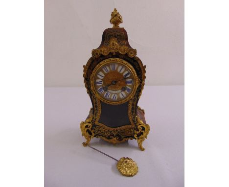 Louis Eschholz Boule mantle clock, gilded dial and Roman numerals with bud finial and four scroll legs, to include pendulum