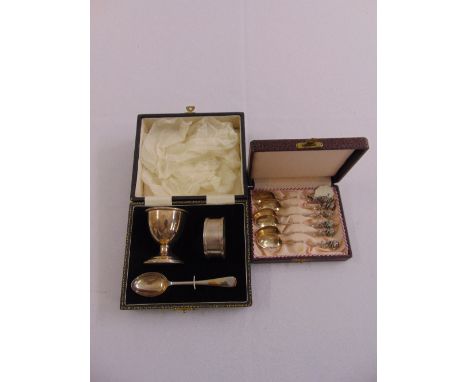 A cased silver Christening set to include egg cup, napkin ring and spoon and a cased set of white metal coffee spoons