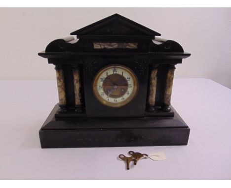 A French black marble mantle clock of architectural form to include key and pendulum