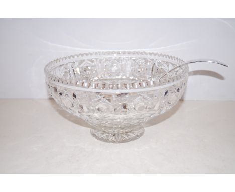 A large cut glass bowl with ladle 