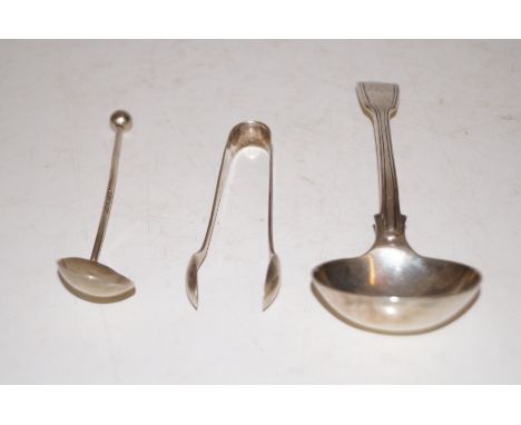 A silver ladle, silver sugar nips and a silver spoon