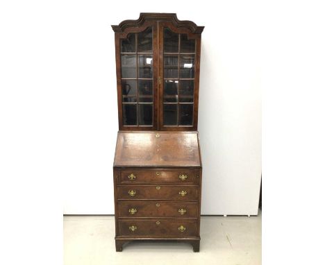 Georgian style walnut crossbanded bureau bookcase, the upper glazed section over hinged fall enclosing stepped fitted interio