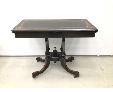 Victorian ebonised and amboyna inlaid card table, with inlaid fold over rounded rectangular top, well below, raised on four c
