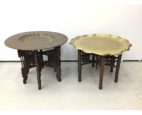 Two Islamic brass top occasional tables, the first with circular tools brass top, 58cm diameter, the second with wavy circula
