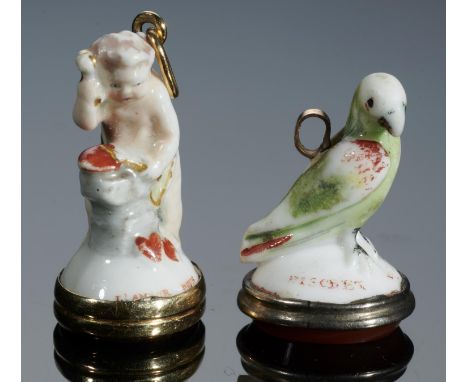 TWO CHELSEA PORCELAIN TOYS, C1756-8  one in the form of Cupid at an anvil, the other a green bird, the mound inscribed in red