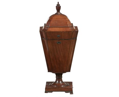 A GEORGE III MAHOGANY CUTLERY URN, C1800  with fitted interior and rising lid, turned finial, on square base and ogee feet, 7