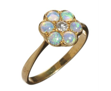 AN OPAL AND DIAMOND CLUSTER RING  in gold marked 18ct, 2.4g, size L½Good condition, opals well matched and of reasonably good