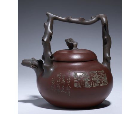 AN YIXING STONEWARE TEAPOT AND COVER, 20TH C with overhead handle of twisted branch pattern, 18.5cm h, marked underneath and 