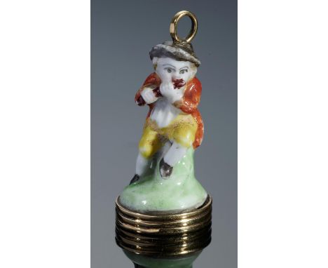 A CHELSEA PORCELAIN TOY, C1756-8  in the form of a flautist seated on a green stump, later mounted in gold as a seal with har