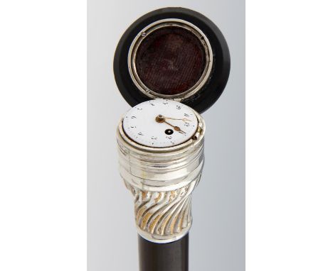 A FRENCH SILVER MOUNTED EBONISED GADGET CANE, EARLY 19TH C  the spirally reeded ogee pommel inset with a verge watch with bri