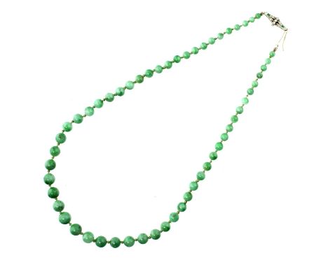 A NECKLACE OF JADE BEADS WITH EMERALD AND DIAMOND CLASP, C1930  in platinum, beads 0.35 - 0.7cm, 50cm lGood condition 