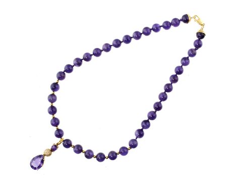 AN AMETHYST AND DIAMOND PENDANT ON A NECKLACE OF AMETHYST BEADS  with larger pear shaped amethyst,  in gold, apparently unmar