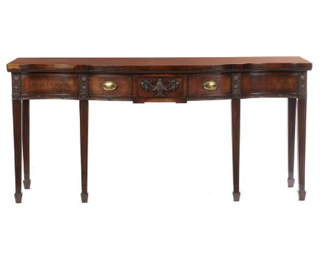 A NEO CLASSICAL STYLE MAHOGANY SERVING TABLE, C1930  the drawer and frieze carved with urn and anthemion, on six fluted squar