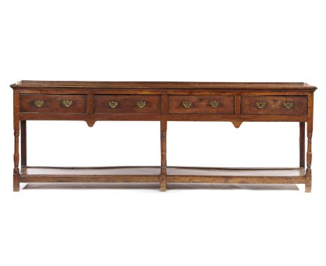 A GEORGE III OAK DRESSER, EARLY 19TH C  fitted with four drawers with pierced brass handles, on turned uprights with pot boar