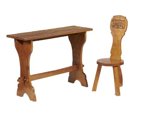 A THOMAS 'GNOMEMAN' WHITTAKER OAK TRESTLE ENDED TABLE AND A SPINNING CHAIR, BOTH 1960-70S table with pegged stretcher, 76cm h