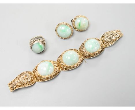 A Chinese filigree gilt white metal and three stone cabochon jade set bracelet, 17cm, a pair of matching ear clips, length 25