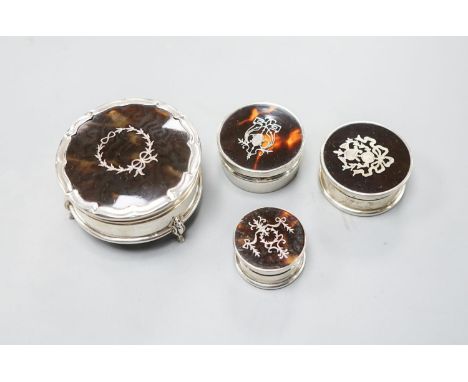 A George V silver and tortoiseshell pique circular trinket box, Birmingham, 1923, 61mm and three other similar smaller boxes 