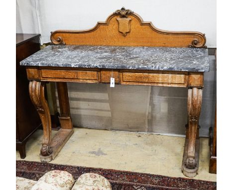 A mid Victorian oak marble topped two drawer console table, width 138cm, depth 54cm, height 120cm