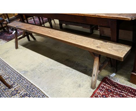 A 19th century French provincial cherry bench seat, length 242cm, depth 46cm, height 46cm