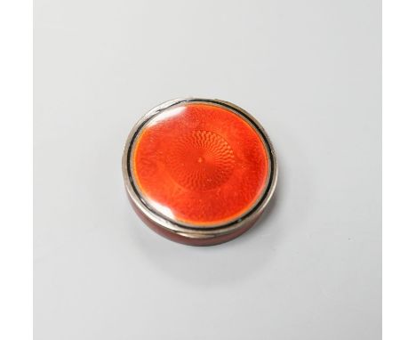 An early 20th century French engine turned white metal and red enamel circular pill box, 40mm.