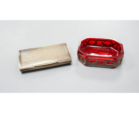 An early 20th century Austro Hungarian gilt white metal snuff box, 82mm and a similar later mounted ruby glass dish, 72mm.