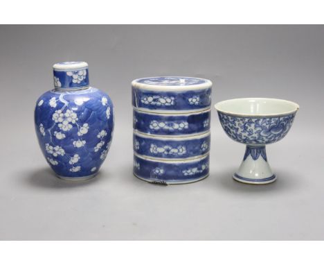 A Chinese blue and white ovoid jar and cover and similar stacking box, Kangxi and a Qing blue and white footed cup, tallest 1