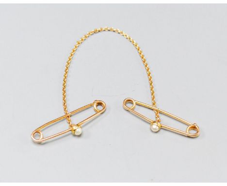 A continental yellow metal and cultured pearl set cloak? pin, gross 6.3 grams.
