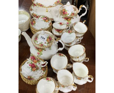 A twelve setting Royal Albert Old Country Roses tea set with two teapots and two milk jugs, together with a cake stand. First