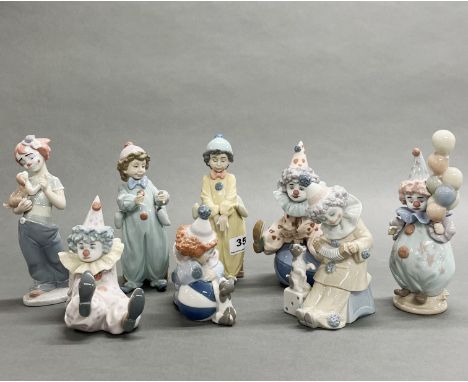 A group of eight Lladro child clown figures, all with boxes.