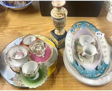 A group of porcelain tea cups and saucers with other items.