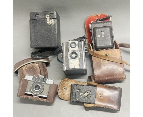 A group of vintage cameras.