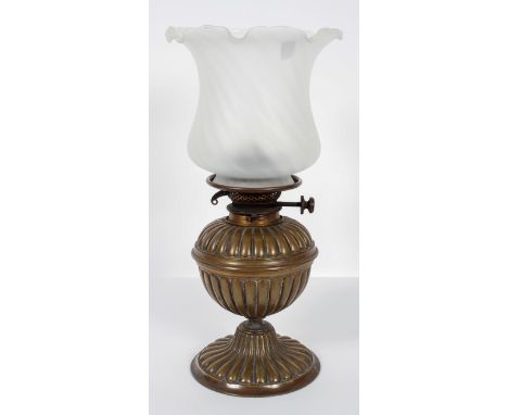 A Victorian brass and glass oil lamp, late 19th century, formed as a gadrooned vase, the burner stamped with 'Hinks &amp; Son