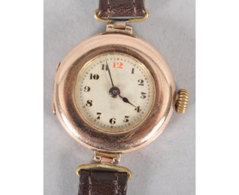 A yellow gold cased Rolex wristwatch. Champagne circular numerical dial. Manual wind movement, signed Rolex 15 jewels. Case r