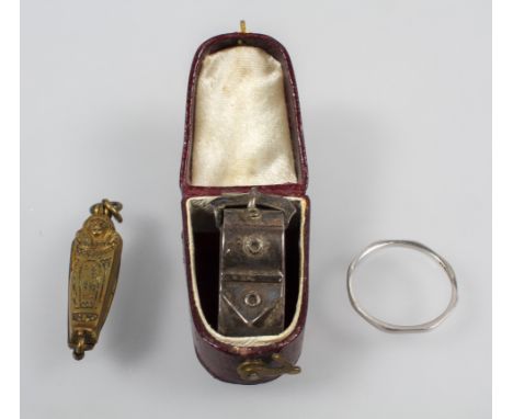 A collection of items: A Platinum 1.50mm wedding ring, size M; A gold plated sarcophagus; A silver scarf buckle, stamped Ster