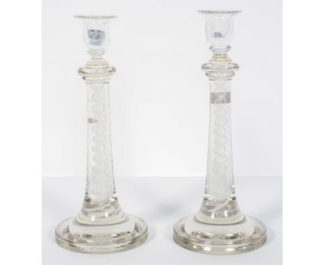 A pair of enamel tourist glass candlesticks with a central helix inside a double spiral, 31cm high (2)
