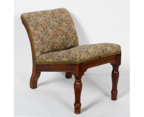 A late 19th century upholstered oak gout stool, with ring turned forelegs, 44cm high (max) x 30cm