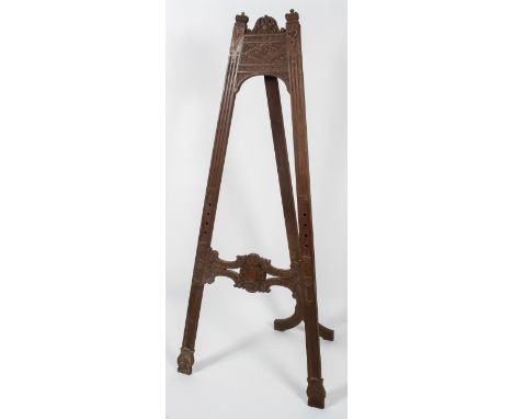 A large Victorian carved wood easel, late 19th century, A-framed, the tall reeded uprights with crown finials and acanthus cr