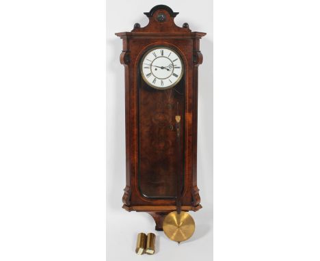 A Vienna regulator wall clock, mid 19th century, veneered in walnut, the classical pediment with ebonised part cut roundel ab