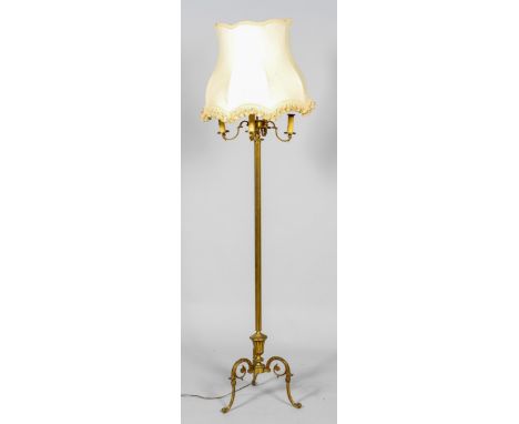 A brass column standard lamp, early 20th century, issuing three S shaped branches and lights flanking a central raised stem s