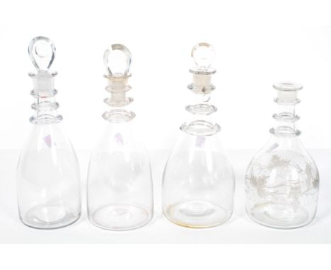 Three similar Georgian style three ring neck decanters, of mallet form, with teardrop stoppers, 30.5cm high and smaller, and 