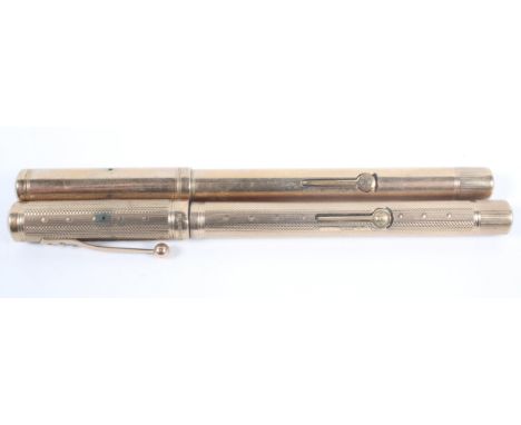 A Waterman's 'Ideal' fountain pen with an engine turned 9ct gold case, London 1929, with inscription; and another with a plai
