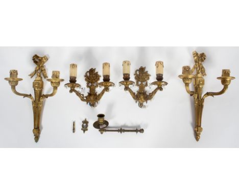  Two pairs of gilt metal twin wall lights, 20th century, the first of neo-Classical form, cast with ribbons, husks and stiff 
