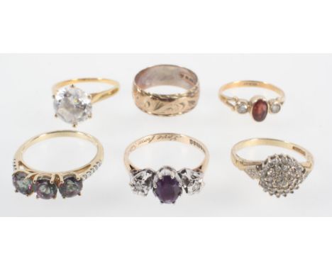 A collection of six rings to include: A 0.25ct (stamped) diamond cluster ring; A three stone garnet and CZ ring; A three ston