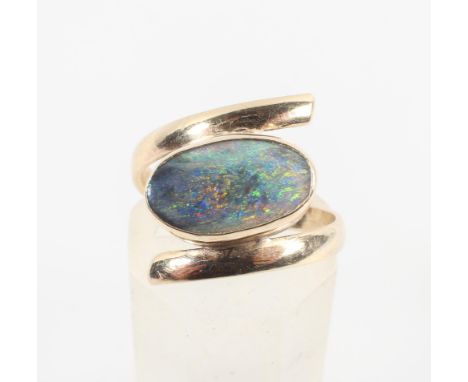 A single stone ring set with an oval cabochon opal. No hallmark - tests indicate gold of approximately 9ct standard. NB: Opal