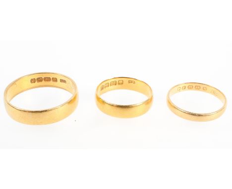 A collection of three wedding rings; 3.0mm / 5.00mm / 5.60mm Size range from K to W. Each individually hallmarked for 22ct go