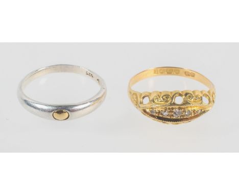 A yellow metal graduated five stone diamond ring, hallmarked 18ct gold, Birmingham, 1918. Size: N ½; together with a plain ba