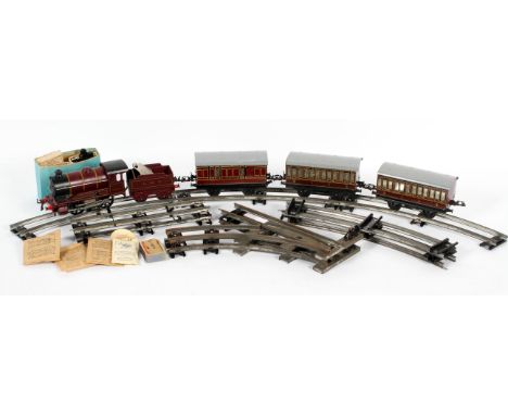 A vintage Hornby '0' gauge tin plate clockwork No 501 passenger train set comprising : a burgundy 0-4-0 Locomotive engine, nu