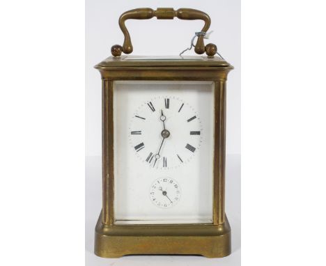 A French brass carriage clock, the enamelled dial with Roman numerals and subsidiary alarm dial, striking to a bell, stamped 